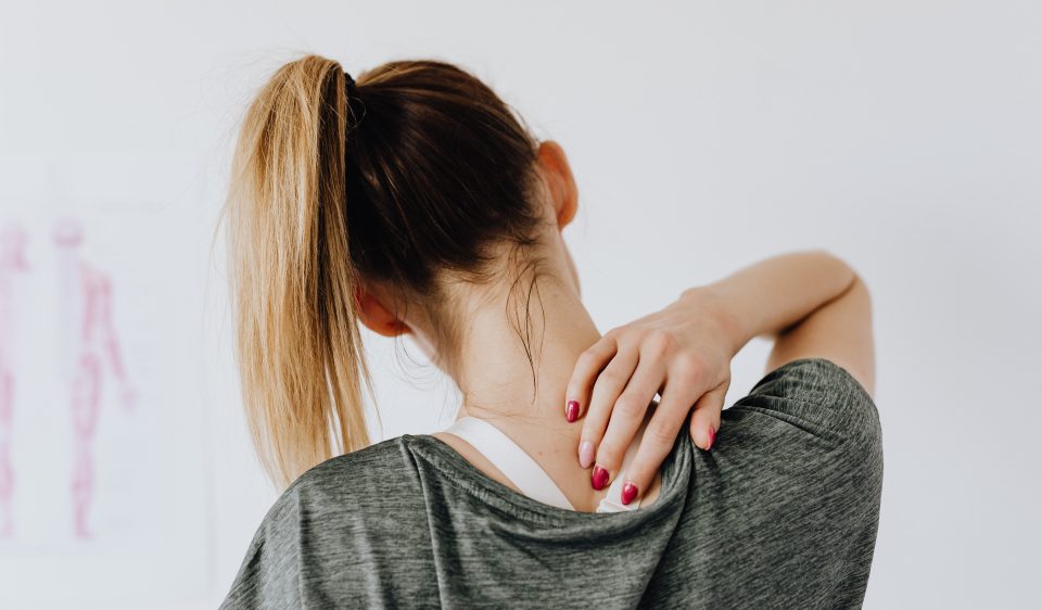 Woman rubbing her neck.